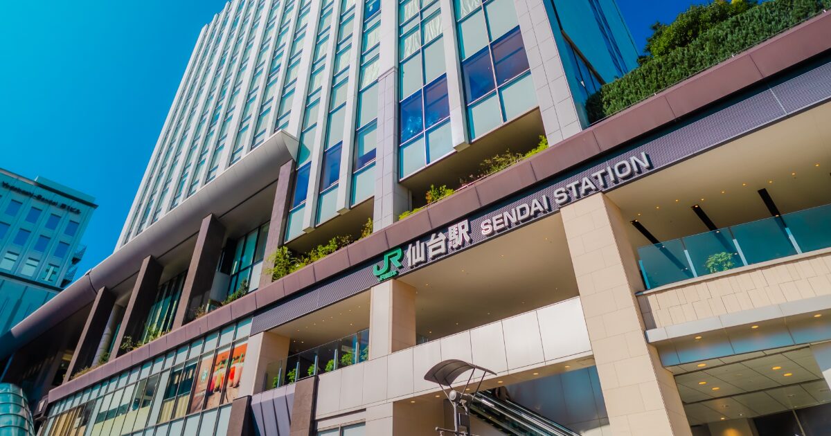 仙台駅東口の高層ビルとJRの駅名サイン